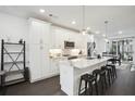 Bright kitchen with white cabinetry, stainless steel appliances, a marble countertop island, and bar stool seating at 1050 Stacks Ave # 1507, Atlanta, GA 30315