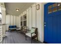 Inviting front porch with seating, a bright blue door, stylish lighting, and a relaxing outdoor space at 1711 Terry Mill Se Rd, Atlanta, GA 30316