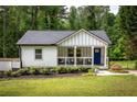 Charming home with a covered porch, blue front door, and a well-maintained lawn and landscaping at 1711 Terry Mill Se Rd, Atlanta, GA 30316