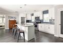 Modern kitchen with a large island, stainless steel appliances, white cabinets, and chic backsplash at 1711 Terry Mill Se Rd, Atlanta, GA 30316