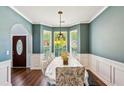Elegant dining room with hardwood floors, bay windows, and stylish chandelier at 2267 Howell Farms Trl, Acworth, GA 30101