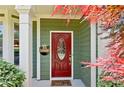 Close-up of a welcoming red front door with decorative glass and a cozy doormat at 2267 Howell Farms Trl, Acworth, GA 30101