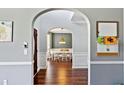 Hallway view with archway leading into a dining room with wood floors at 2267 Howell Farms Trl, Acworth, GA 30101