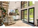 Bright foyer boasts an open staircase, large windows, and sleek, contemporary design at 2469 River Oak Dr, Decatur, GA 30033
