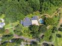 Expansive property with a home, pool, and verdant landscaping surrounded by mature trees at 269 Red Gate Dr, Canton, GA 30115
