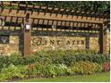 Stone entrance with the Bentwater name, showcasing landscaping with flowers and greenery at 71 Tobinleigh Ct, Acworth, GA 30101