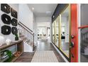 Stylish entryway featuring elegant decor, wood flooring, staircase, and a view into a bright living room at 602 Belshire Dr, Acworth, GA 30102