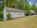 Charming home with a screened in porch, light-gray siding, and a well-maintained lawn at 244 Pauladean Se Cir, Marietta, GA 30067