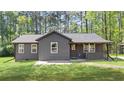 Exterior of home with a dark gray paint, front porch, and green lawn at 3917 Dallas Acworth Nw Hwy, Acworth, GA 30101