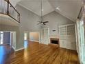 Open-concept living room with fireplace, built-ins, and hardwood floors at 610 Brington Close, Alpharetta, GA 30022