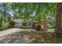 Brick and siding exterior with a ramp to the front door for accessibility and mature trees at 2591 Boulder Hill Se Ct, Atlanta, GA 30316
