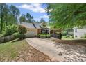 Two-story home with a driveway, landscaped front yard, and a ramp for accessibility at 2591 Boulder Hill Se Ct, Atlanta, GA 30316