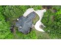 Aerial shot of home with circular driveway amid manicured lawns and mature trees, highlighting its private setting at 3 Woodlawn Ne Dr, Marietta, GA 30067