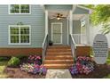 Charming front porch with beautifully landscaped garden beds and an inviting entryway at 1008 Lena Nw St, Atlanta, GA 30314