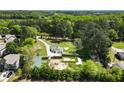 Aerial view of property showcasing its location near lush trees and a lake at 3556 Finch Sw Rd, Powder Springs, GA 30127