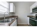 Functional kitchen featuring stainless steel appliances, double basin sink and white cabinets at 3721 Longview Dr, Douglasville, GA 30135