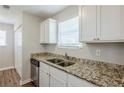 Stylish kitchen with white cabinets, granite counters, stainless steel appliances, and hardwood flooring at 6895 Brown S Dr, Fairburn, GA 30213