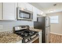 Modern kitchen showcasing stainless steel appliances, granite counters and white cabinets at 6895 Brown S Dr, Fairburn, GA 30213