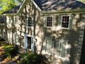 Stylish home exterior featuring manicured front yard with traditional windows and trimmed bushes at 7635 Blandford Pl, Atlanta, GA 30350