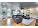 Inviting living room with hardwood floors, fireplace, large windows, and comfortable, oversized sectional seating at 7635 Blandford Pl, Atlanta, GA 30350