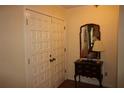 Hallway featuring a patterned door, mirror, and decorative table at 2977 Karen Ln, Marietta, GA 30062
