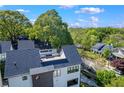 An aerial perspective showcasing a neighborhood with lush greenery and modern homes with rooftop patios at 1331 Iverson Ne St # A, Atlanta, GA 30307