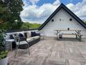 Relax on this rooftop deck with comfortable seating and dining table, offering an inviting outdoor retreat at 1331 Iverson Ne St # A, Atlanta, GA 30307
