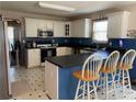 Stylish kitchen with white cabinetry, black countertops, and stainless appliances, plus eat-in breakfast bar at 33 Ashland Cir, Douglasville, GA 30134