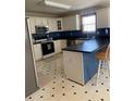 Well-lit kitchen featuring white cabinets, black countertops, and modern stainless steel appliances at 33 Ashland Cir, Douglasville, GA 30134