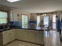 Bright eat-in kitchen with white cabinetry, black countertops, and adjacent dining space at 33 Ashland Cir, Douglasville, GA 30134