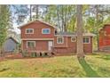 Exterior view of a two-story home featuring a wood deck and spacious backyard at 5350 Rockbridge Rd, Stone Mountain, GA 30088
