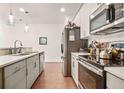 Galley-style kitchen with stainless steel appliances and white countertops, offering ample space and modern design at 6322 Scudders Dr, Lithonia, GA 30058