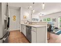 Modern kitchen featuring stainless steel appliances, white cabinets, and open layout to the living room at 6322 Scudders Dr, Lithonia, GA 30058