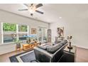 Bright living room featuring hardwood floors, large windows, and a comfortable leather sofa at 6322 Scudders Dr, Lithonia, GA 30058