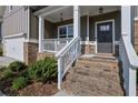Inviting front entrance with brick steps and a covered porch at 5985 Hidden Ridge Ct, Cumming, GA 30028