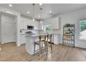 Bright kitchen featuring white cabinetry, granite countertops, and stainless steel appliances at 5985 Hidden Ridge Ct, Cumming, GA 30028