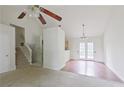 Open-concept living space with staircase, hardwood flooring and glass doors leading to outdoor space at 3311 Basking Shade Ln, Decatur, GA 30034