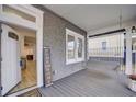 Inviting front porch featuring a cozy porch swing and stylish decor, leading into the home's entrance at 1463 Metropolitan Sw Pkwy, Atlanta, GA 30310