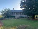 Inviting single-Gathering home with a classic front porch, surrounded by mature trees and a well-maintained lawn at 1424 Belmont Rd, Villa Rica, GA 30180