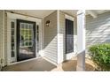 A home's entrance with a black front door and a decorative pillar at 210 Arbor Creek Dr, Dallas, GA 30157