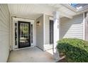 Close-up of a home's front entrance, featuring a black door with glass panes at 210 Arbor Creek Dr, Dallas, GA 30157