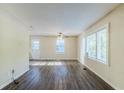 Bright living room showcasing laminate flooring, fresh paint, and natural light from large windows at 2910 Diana Sw Dr, Atlanta, GA 30315