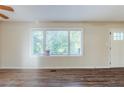 Inviting living room featuring laminate flooring, fresh paint, and natural light from large windows at 2910 Diana Sw Dr, Atlanta, GA 30315