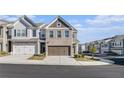Beautiful townhome with a two-car garage and charming brick and siding exterior at 7676 Viking Rd, Fairburn, GA 30213