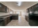 View of a modern kitchen, with dark cabinets, an open layout, and durable tile flooring at 1401 Kala Dr, Lithonia, GA 30058