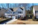Charming townhome with a two-car garage, black shutters, and manicured landscaping at 3723 Verde Glen Ln, Cumming, GA 30040