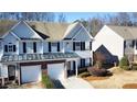 Charming townhome with a two-car garage, black shutters, and an inviting entrance at 3723 Verde Glen Ln, Cumming, GA 30040