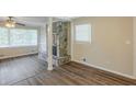 Open-concept living area features a stone fireplace, wood floors, and ample natural light at 7268 Westwood Ln, Douglasville, GA 30134