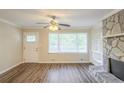 Bright living room with a stone fireplace, built-in shelves, and new flooring at 7268 Westwood Ln, Douglasville, GA 30134