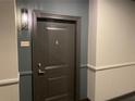 Apartment door with unit number and modern wall-mounted light fixture at 901 Abernathy Ne Rd # 5050, Atlanta, GA 30328